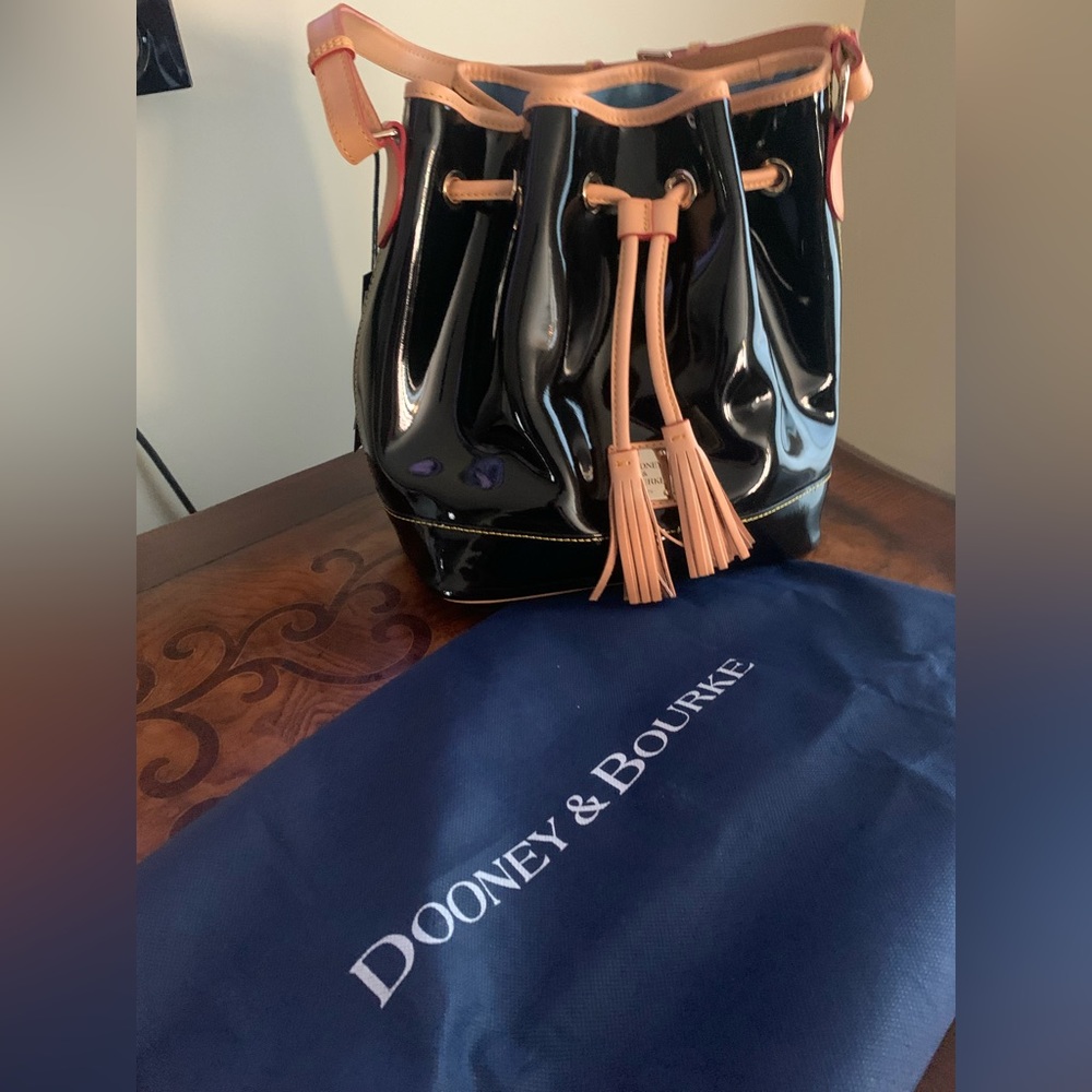 NWT Dooney & Bourke black patent leather bucket drawstring bag.
